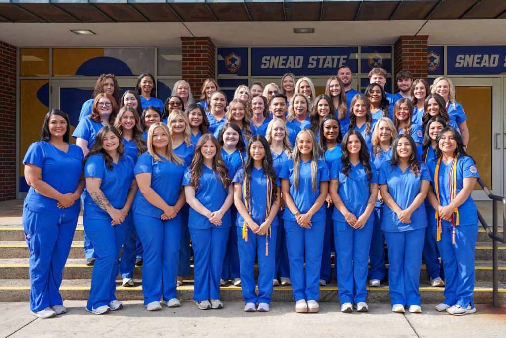 group of student nurses posting for a photo at their pinning ceremony